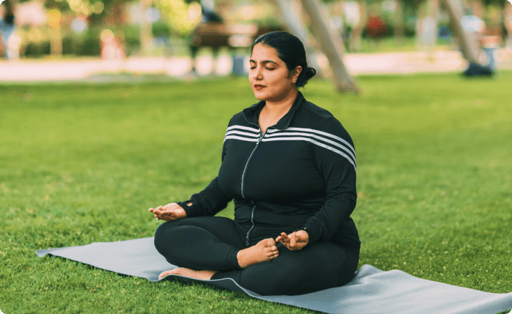 Guest meditating outdoors during an Ayurvedic wellness routine
